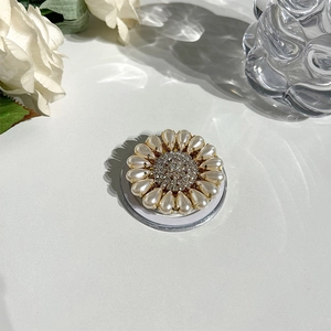 Close-up of Magsafe phone grip with sunflower rhinestone design and pearl accents