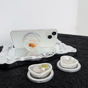 Detail of magnetic heart-shaped phone grips with pearl and opal resin stones