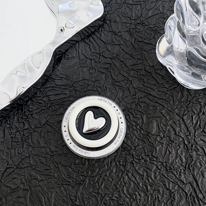 Macro detail of magnetic heart phone grip with silver texture and Gift For You lettering