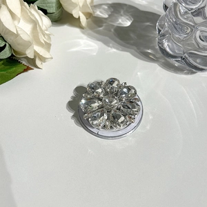 Close-up of a sparkling crystal flower MagSafe phone socket with luxury rhinestones