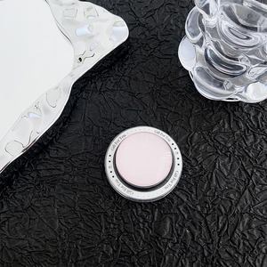 Detail of pink magnetic phone socket with Gift For You print on dark textured backdrop