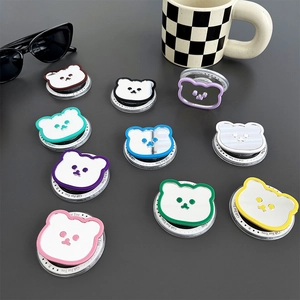 Set of 10 bear shaped MagSafe mirror phone grips in various colors on a gray desk