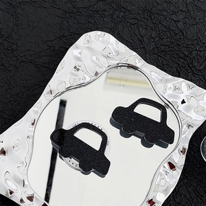 Glittery black car-shaped expandable phone socket stand with circular adhesive base