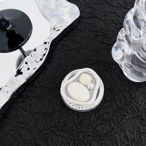 Top view of a round magnetic phone grip with pearl accents and Gift For You text