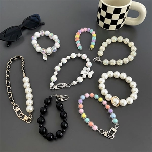 Collection of stylish pearl and colorful beaded phone wrist straps with bows and chains