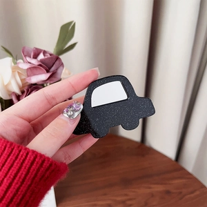 Close-up of glittery black car-shaped grip holder showing fine textures and details