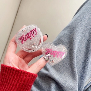 Detail of glitter heart phone grip with pink Happy lettering and Gift For You text