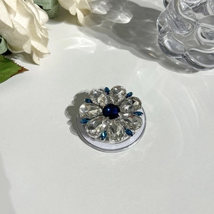 Detail of flower-shaped MagSafe phone stand with blue rhinestones and crystal accents
