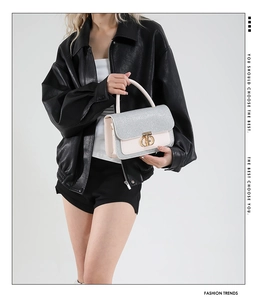 Detailed view of silver glitter flap and pink crossbody bag with golden CD lock