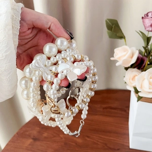 Detail of elegant pearl phone lanyard with bow accent and durable metal clasps
