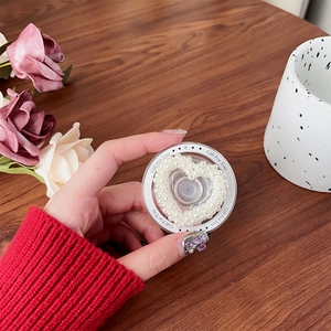 Close-up of magnetic phone grip with heart-shaped pearls and Gift For You text decoration