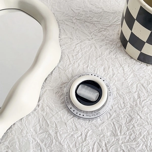 Macro shot of phone socket with grey cat eye stone and Gift For You text on white background