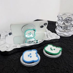 Magnetic bear phone grip with mirror and MagSafe support on stylish silver tray