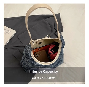 Detail view of large tweed shoulder bag interior capacity with magnetic closure