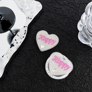 Heart-shaped glitter phone grip with Happy lettering and rhinestone on black background