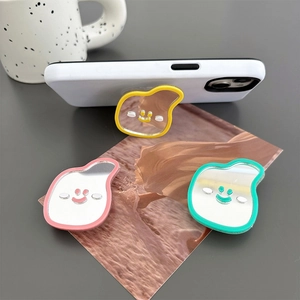 Adjustable smiley face cell phone grip with mirror in yellow, pink and green colors