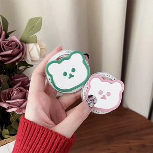 Close-up of pink and green magnetic cartoon bear phone sockets with Gift For You text