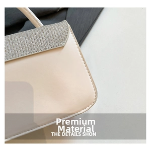Detail shot of beige faux leather bag featuring silver glitter flap and fine stitching