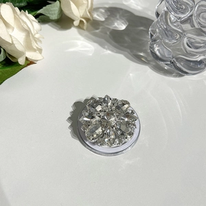 Macro detail of luxury rhinestone floral Magsafe phone grip with crystal petal design