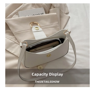 Interior view showing the storage capacity of a white minimalist shoulder bag