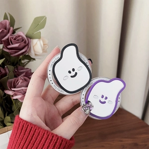 Close-up of cute smiley face phone grip with white irregular design and star pattern