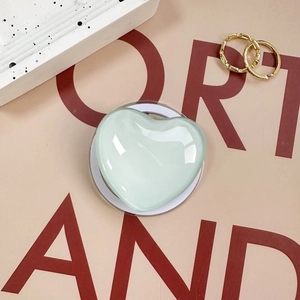 Pale green glass heart phone grip stand with translucent finish and round base