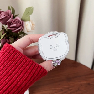 Close-up of white bear phone grip with Gift For You print and foldable magnetic stand