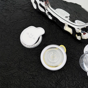 Macro detail of white smiley face griptok with Gift For You text and wavy clear phone case