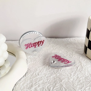 Detail view of heart shaped phone socket with pink Happy text and silver glitter