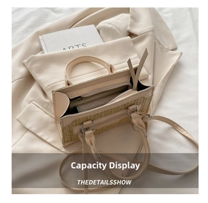 Detail view of woven straw tote bag showing spacious interior with zipper pocket