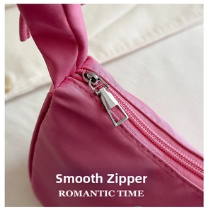 Macro detail of the smooth pink nylon fabric and high-quality silver metal zipper on bag