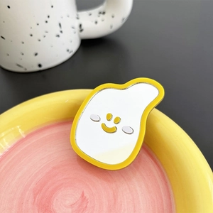 Close-up of a yellow banana-shaped mirror phone socket with a minimalist smile face