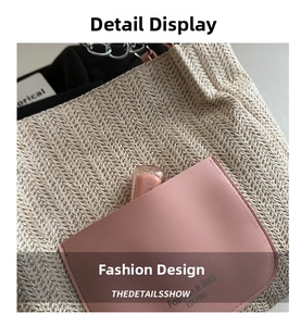 Detailed close-up of woven straw tote bag with pink leather pocket and metal chain strap