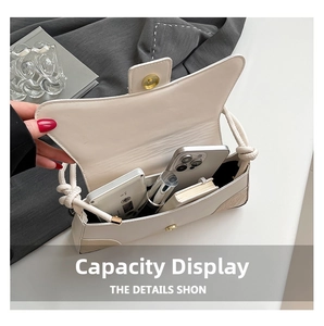 Interior view showing capacity for phone and lipstick in beige faux leather bag