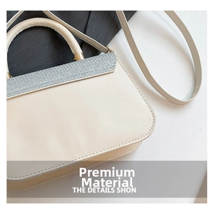 Detail of beige faux leather bag featuring silver glitter flap and gold hardware