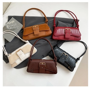 Detail of five crocodile pattern shoulder bags in caramel, burgundy, white, and coffee colors