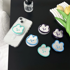 Cute bunny-shaped phone grip with mirror and retractable stand on a modern desk