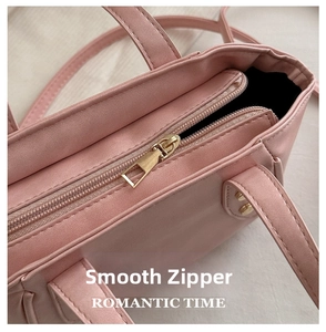 Detailed shot of smooth golden zipper closure on a pink bucket bag with PU leather texture
