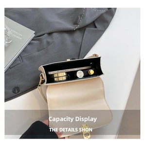 Internal view of cream leather shoulder bag showing storage for phone and makeup