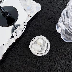 Detailed view of a 3D heart pearl phone grip holder with silver metallic textures
