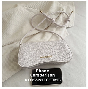 Detail view of woven pattern and gold logo on a retro white vintage underarm bag
