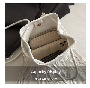 Internal view of white litchi leather bucket bag showing phone and wallet storage space