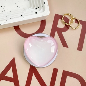 Pink heart-shaped magnetic phone grip with a translucent jelly texture and round base
