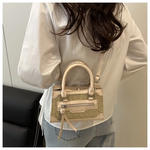Mini crossbody bag with cream leather and straw texture shown in a casual lifestyle setting