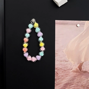 Detail of macaron heart beads and silver ring hook for mobile phone strap