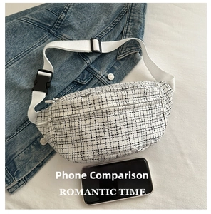 Detail of checkered tweed chest bag with nylon strap and black plastic buckle on denim