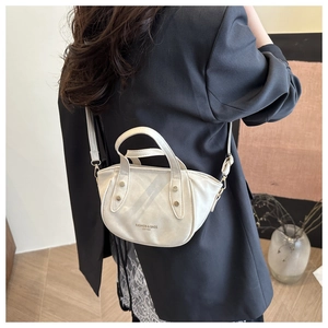 Minimalist white bucket bag with 'FASHION & BAGS' text shown on a crossbody model