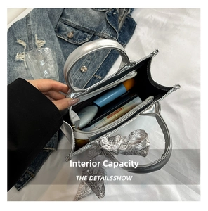 Interior view of silver tote bag showing compartments, black lining and decorative scarf