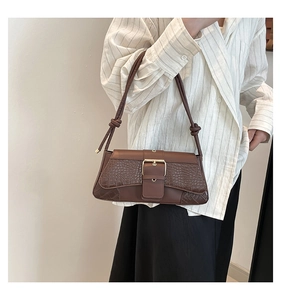 Brown faux leather shoulder bag with crocodile pattern texture shown on model