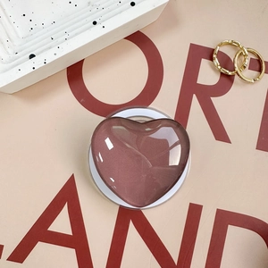 Solid color heart-shaped phone grip in glossy mauve pink with a transparent base